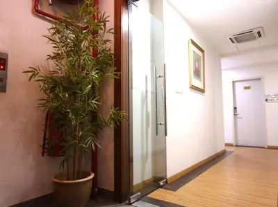 a plant in a large pot in a hallway at ECO Hotel at BBCC in Kuala Lumpur