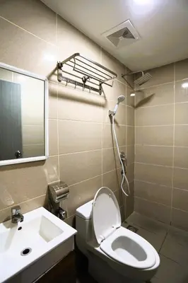 a bathroom with a toilet and a sink and a mirror at ECO Hotel at BBCC in Kuala Lumpur