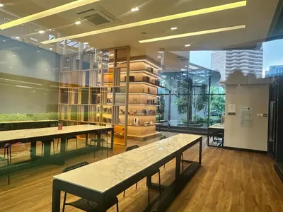 a room with benches and tables in a building at STAR Residence KLCC City Centre in Kuala Lumpur
