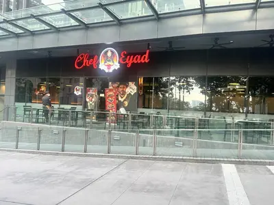 a man standing in front of a restaurant at STAR Residence KLCC City Centre in Kuala Lumpur