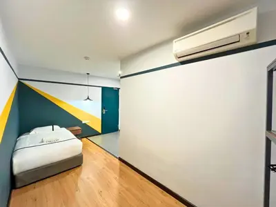 a bedroom with a bed and a painting on the wall at Sky Hotel Cheras Maluri in Kuala Lumpur