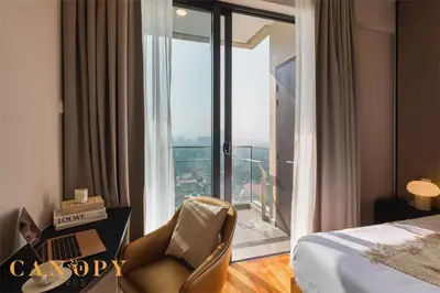 a hotel room with a bed and a desk with a laptop at The Manor Signature Residence, Kuala Lumpur in Kuala Lumpur