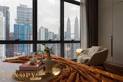a living room with a view of a city from a window at The Manor Signature Residence, Kuala Lumpur in Kuala Lumpur