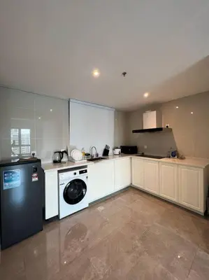 a kitchen with a washing machine and a washer at Ooak suites Mont Kiara 163 \uc624\ud06c\uc2a4\ud14c\uc774 in Kuala Lumpur