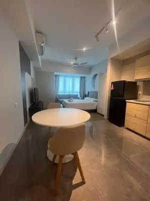 a table and a chair in a room with a kitchen at The Ooak Kiara 163 in Kuala Lumpur