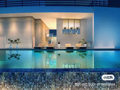 a large swimming pool in a building with chairs at The Ooak Kiara 163 in Kuala Lumpur