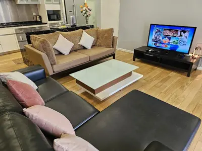 a living room with a couch and a tv at St Mary Pavilion KLCC 3BR6Pax in Kuala Lumpur