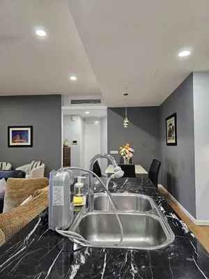 a kitchen with a sink and a living room at St Mary Pavilion KLCC 3BR6Pax in Kuala Lumpur