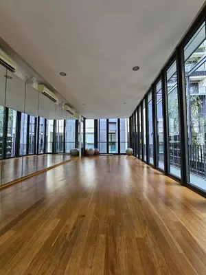 an empty room with wooden floors and large windows at St Mary Pavilion KLCC 3BR6Pax in Kuala Lumpur
