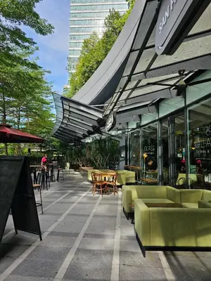 a patio with chairs and tables and a building at St Mary Pavilion KLCC 3BR6Pax in Kuala Lumpur