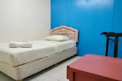 a bedroom with a bed and a red table at Hotel Dlima House Bukit Bintang in Kuala Lumpur
