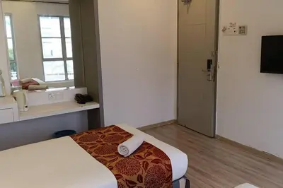 a small room with a bed and a bathroom at Hotel Dlima House Bukit Bintang in Kuala Lumpur