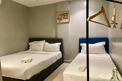 a room with two beds with towels on them at Hotel Dlima House Bukit Bintang in Kuala Lumpur
