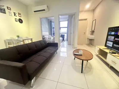 a living room with a couch and a table at Simple Arte Mont Kiara 2 , MITEC Matrade Publika in Kuala Lumpur