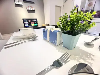 a table with a fork and a potted plant on it at Simple Arte Mont Kiara 2 , MITEC Matrade Publika in Kuala Lumpur