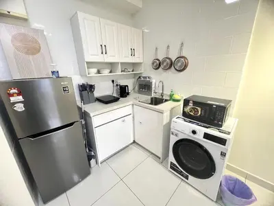 a kitchen with a refrigerator and a washer at Simple Arte Mont Kiara 2 , MITEC Matrade Publika in Kuala Lumpur