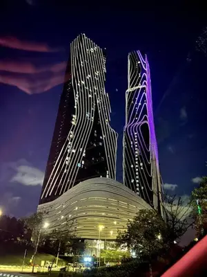 two tall skyscrapers in a city at night at Simple Arte Mont Kiara 2 , MITEC Matrade Publika in Kuala Lumpur