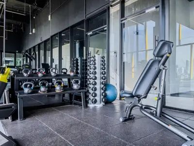 a room with a gym with a chair and balls at Opus Residences by Wakely Kuala Lumpur in Kuala Lumpur