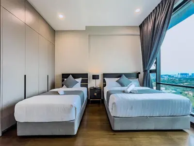 two beds in a room with a window at Opus Residences by Wakely Kuala Lumpur in Kuala Lumpur