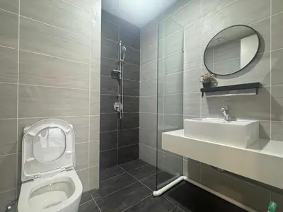 a bathroom with a toilet and a sink and a mirror at Trion Kuala Lumpur Superior room nearby mrt in Kuala Lumpur