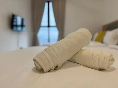 a rolled up towel on top of a bed at Trion Kuala Lumpur Superior room nearby mrt in Kuala Lumpur