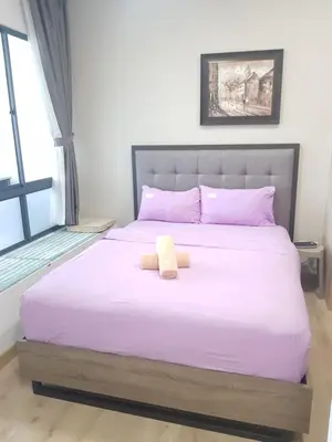 a bed with a teddy bear sitting on it at CityStay at Luxe Colony KLCC in Kuala Lumpur