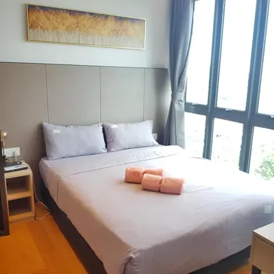 a bedroom with a bed with two towels on it at CityStay at Luxe Colony KLCC in Kuala Lumpur