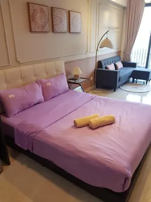 a large purple bed with two yellow pillows on it at CityStay at Luxe Colony KLCC in Kuala Lumpur