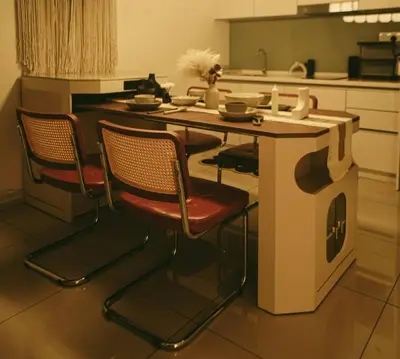 a kitchen with two chairs and a table with a stove at Tranquil Den EkoCheras KL in Kuala Lumpur