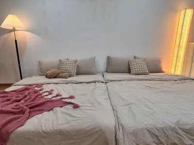 a large bed with a blanket on top of it at Tranquil Den EkoCheras KL in Kuala Lumpur
