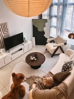 a living room with a dog sitting on a couch at Tranquil Den EkoCheras KL in Kuala Lumpur