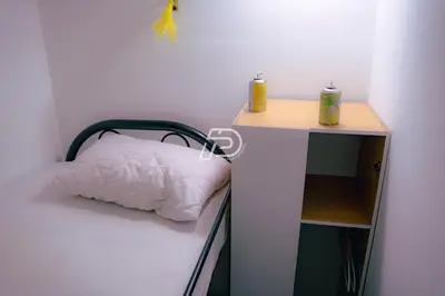 a bedroom with a bed and a desk with two candles at Infinity Pool Dorms KLCC View by Regalia in Kuala Lumpur
