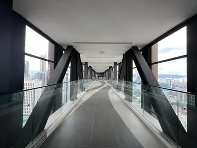 a glass walkway in a building with windows at Cozy Axon Residence Bukit Bintang by Konoha Suites 1-3pax in Kuala Lumpur