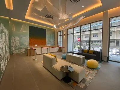 a lobby with couches and tables in a building at Upper Hotel Suites KL Sentral in Kuala Lumpur