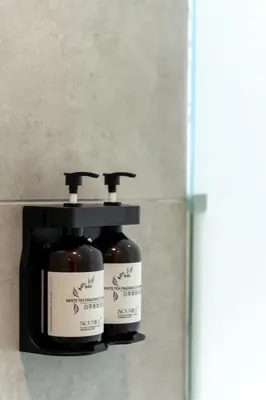 two bottles of soap sitting next to each other at Upper Hotel Suites KL Sentral in Kuala Lumpur