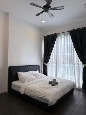 a bedroom with a bed with a ceiling fan at Cozy Downtown 2BR at M Suites, Embassy Row in Kuala Lumpur