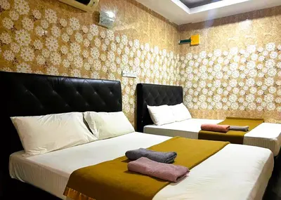 two beds in a room with two beds sidx sidx sidx at ARK Ampang Tesco Hotel in Kuala Lumpur