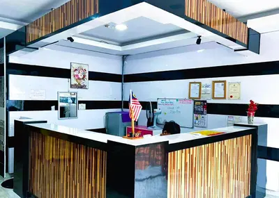 a lobby with a counter with an american flag at ARK Ampang Tesco Hotel in Kuala Lumpur