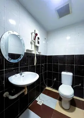 a bathroom with a toilet and a sink at ARK Ampang Tesco Hotel in Kuala Lumpur