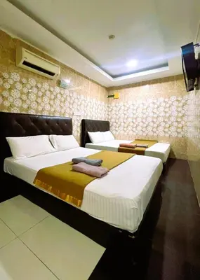 a bedroom with two beds and a tv on the wall at ARK Ampang Tesco Hotel in Kuala Lumpur