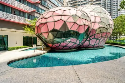 a large ball sculpture in front of a building at Arte Plus Jalan Ampang, KLCC Level 35 in Kuala Lumpur