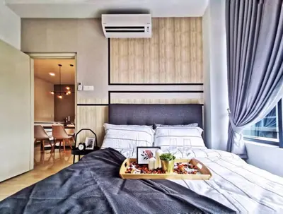 a bedroom with a tray of food on a bed at Arte Plus Jalan Ampang, KLCC Level 35 in Kuala Lumpur