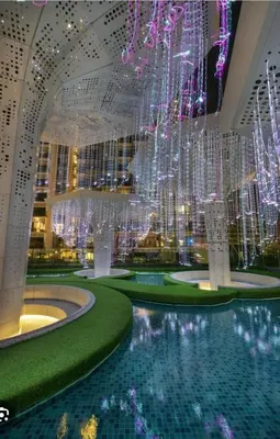 a hotel lobby with a pool and a chandelier at Arte Plus Jalan Ampang, KLCC Level 35 in Kuala Lumpur