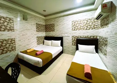 a room with two beds and a table in it at ARK Wave Hotel Ampang in Ampang