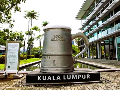 a large metal mug on display in front of a building at ARK Wave Hotel Ampang in Ampang