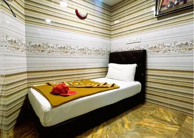 a bedroom with a bed in a room with striped walls at ARK Wave Hotel Ampang in Ampang