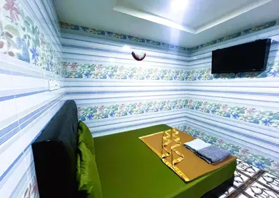 a room with a table and a tv in it at ARK Wave Hotel Ampang in Ampang