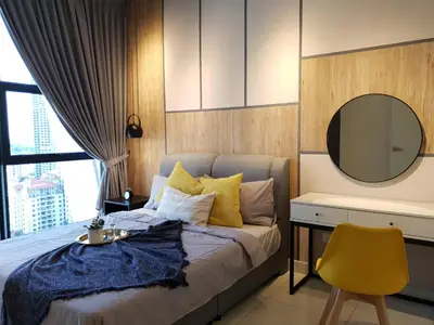 a bedroom with a bed with a mirror and a yellow chair at Arte Mont Kiara Studio,Kuala Lumpur in Kuala Lumpur