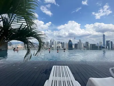 a swimming pool with a city skyline in the background at Nice stay by regalia in Kuala Lumpur