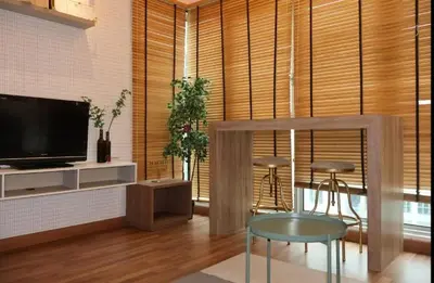a living room with a television and a table and chairs at Nice stay by regalia in Kuala Lumpur